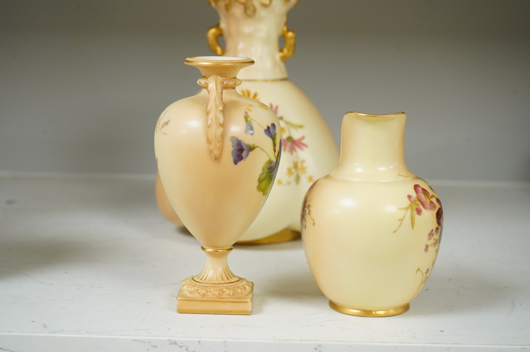 Three pieces of Royal Worcester blush ivory porcelain vessels, tallest 20cm